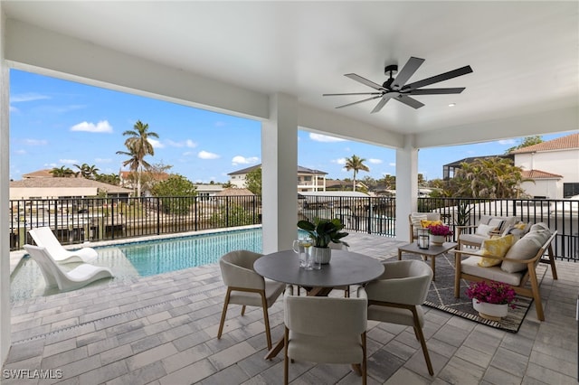 view of pool with ceiling fan, a patio area, and an outdoor hangout area