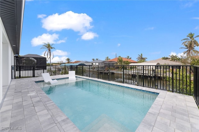 view of pool with a lanai and a water view