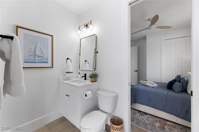 bathroom with vanity, ceiling fan, toilet, and wood-type flooring