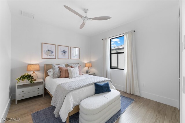 bedroom with ceiling fan and light wood-type flooring