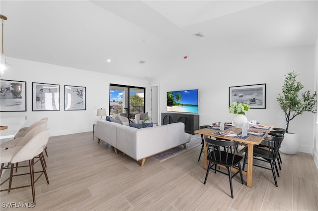 living room featuring lofted ceiling