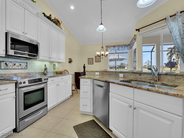 kitchen featuring sink, light stone counters, pendant lighting, stainless steel appliances, and white cabinets