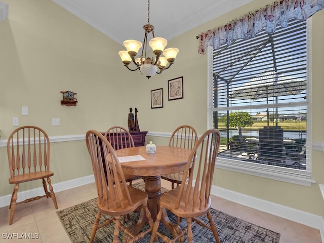 dining area with light tile patterned flooring, a chandelier, and crown molding