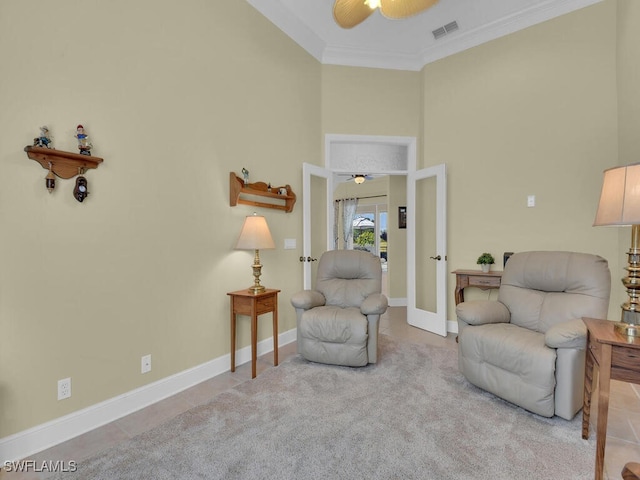 living area with ornamental molding, french doors, ceiling fan, and a high ceiling