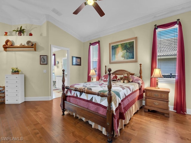 bedroom with wood-type flooring, vaulted ceiling, ornamental molding, and ceiling fan