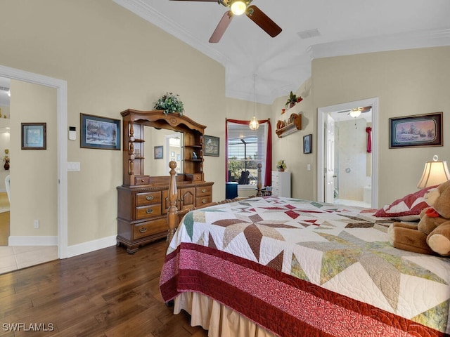 bedroom with lofted ceiling, dark hardwood / wood-style flooring, ceiling fan, crown molding, and ensuite bath