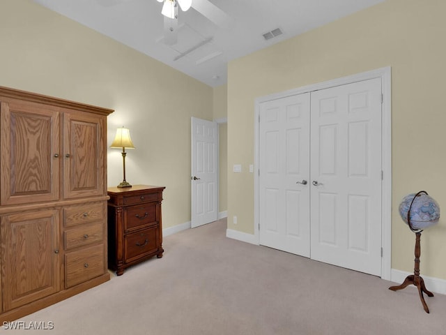 bedroom with ceiling fan, a closet, and light carpet