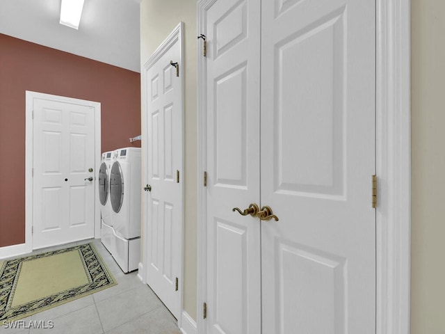 laundry room with light tile patterned flooring and washer and dryer