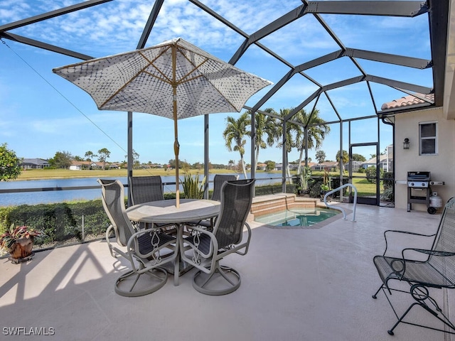 view of patio / terrace with a lanai, grilling area, a hot tub, and a water view