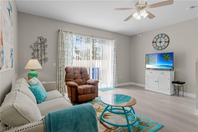 living room featuring light hardwood / wood-style flooring and ceiling fan