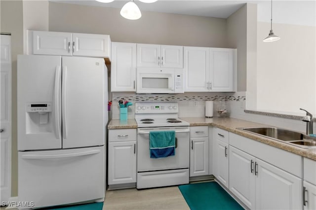 kitchen with sink, white cabinetry, tasteful backsplash, decorative light fixtures, and white appliances