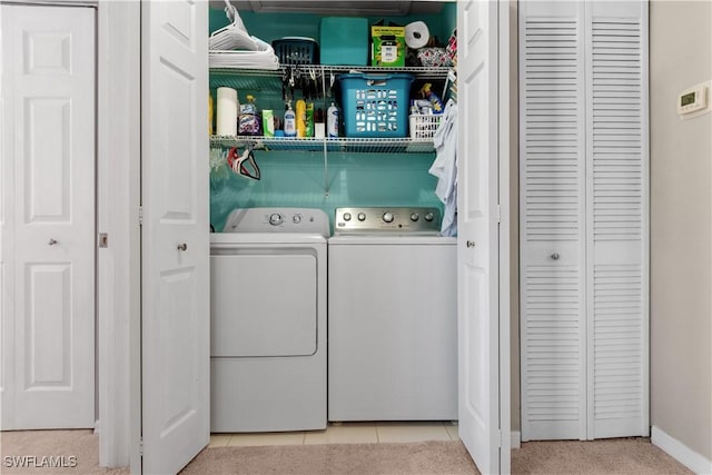 laundry area featuring tile patterned floors and washing machine and dryer