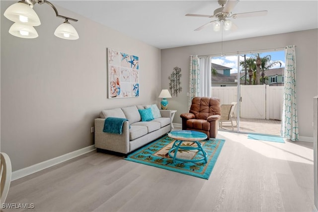 living room with ceiling fan and light hardwood / wood-style flooring