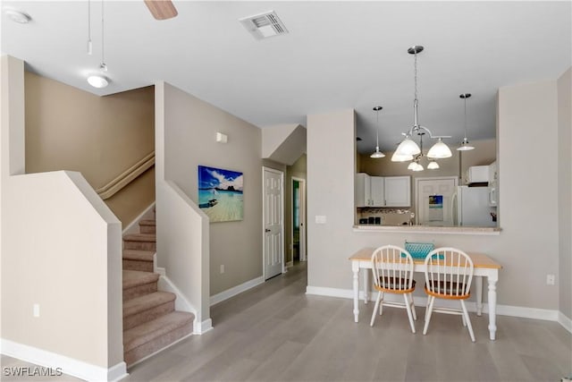 dining space featuring ceiling fan and light hardwood / wood-style flooring