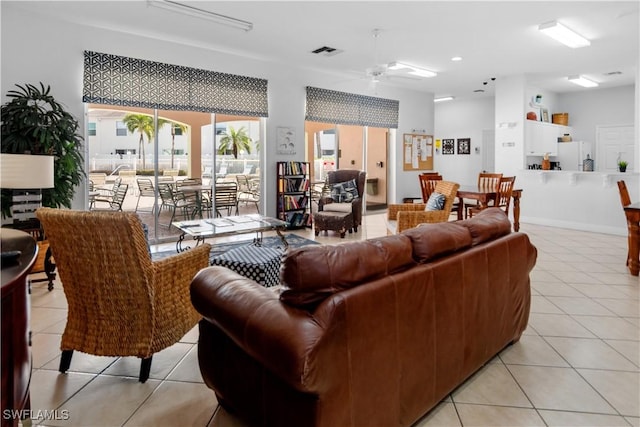 living room with light tile patterned floors and ceiling fan