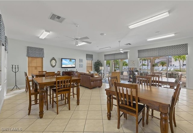 tiled dining space with ceiling fan