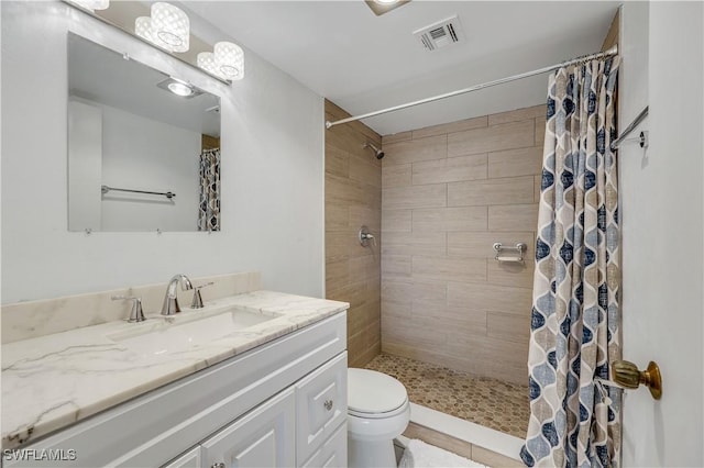 bathroom featuring a shower with curtain, vanity, and toilet