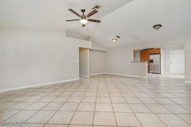 tiled spare room featuring ceiling fan and vaulted ceiling