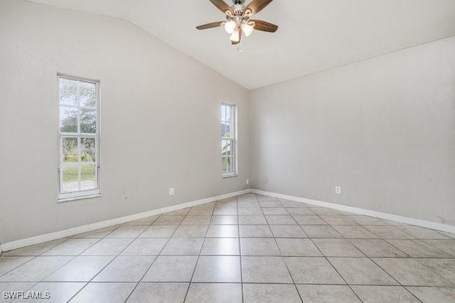 unfurnished room featuring vaulted ceiling, ceiling fan, and light tile patterned floors