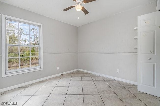 spare room featuring ceiling fan and light tile patterned floors