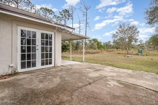 view of patio with a playground and french doors