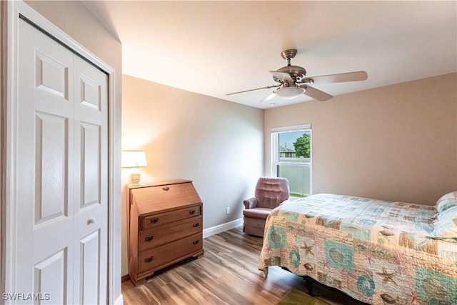 bedroom featuring ceiling fan, a closet, and light hardwood / wood-style flooring