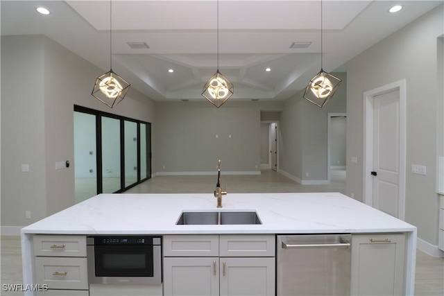 kitchen with white cabinetry, light stone countertops, sink, and hanging light fixtures