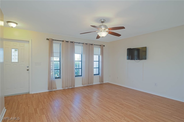 spare room featuring light hardwood / wood-style floors and ceiling fan