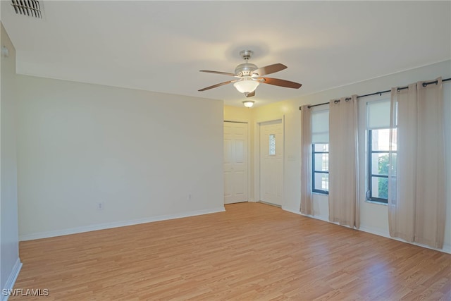 empty room featuring ceiling fan and light hardwood / wood-style flooring