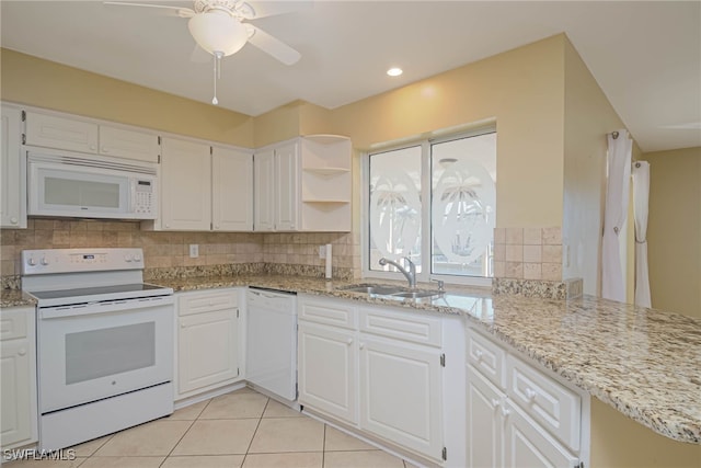 kitchen featuring white cabinetry, light stone countertops, sink, and white appliances