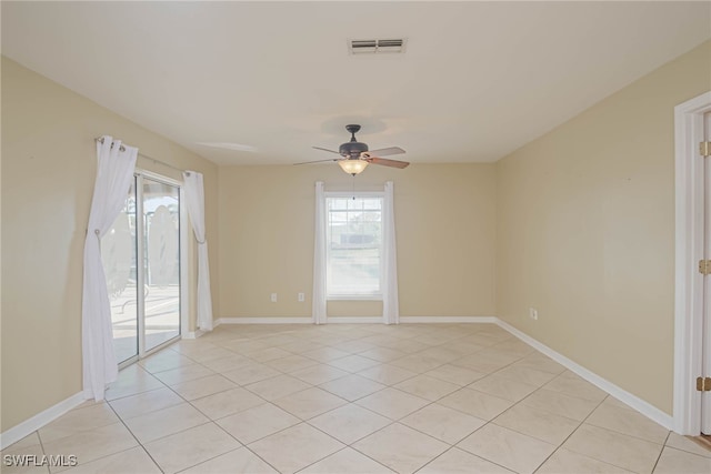 tiled spare room featuring ceiling fan