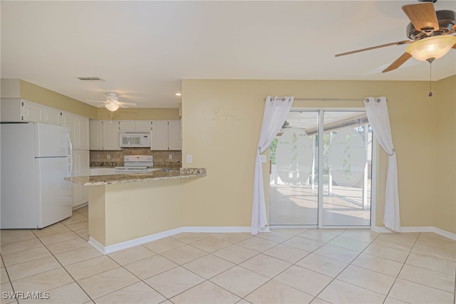 kitchen with white cabinetry, kitchen peninsula, white appliances, light stone countertops, and decorative backsplash