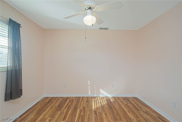 spare room with hardwood / wood-style floors and ceiling fan