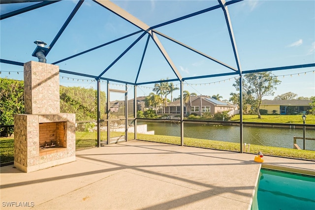 view of patio / terrace featuring a water view, exterior fireplace, and glass enclosure