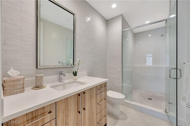 1115 Central Ave Unit 457, Naples, FL 34102 - bathroom featuring vanity, toilet, tile walls, tile patterned floors, and a stall shower