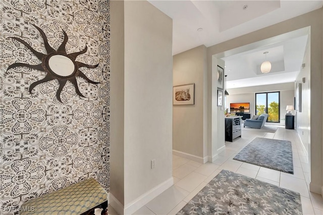 1115 Central Ave Unit 457, Naples, FL 34102 - corridor with baseboards, tile patterned flooring, and a tray ceiling