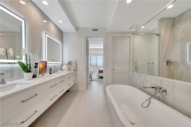 bathroom featuring vanity, independent shower and bath, and tile patterned flooring