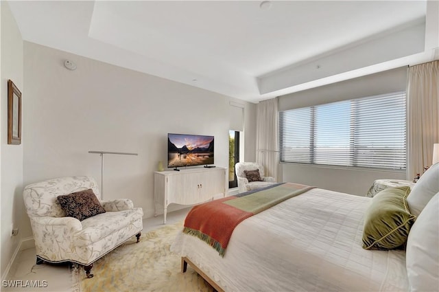 bedroom featuring a raised ceiling and carpet floors