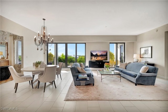 living room featuring plenty of natural light, light tile patterned floors, and a notable chandelier