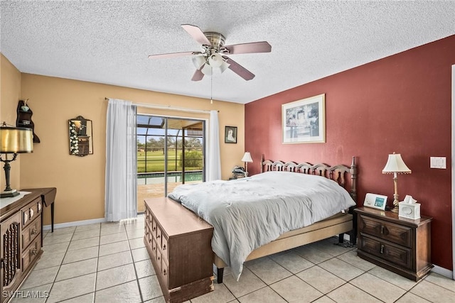 tiled bedroom with a textured ceiling, access to exterior, and ceiling fan