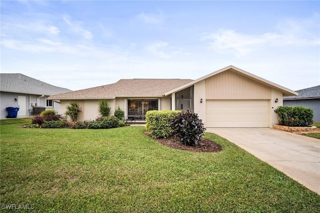 single story home with a garage and a front lawn