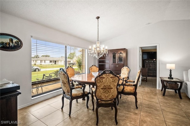 dining room with vaulted ceiling, light tile patterned floors, a textured ceiling, and a chandelier