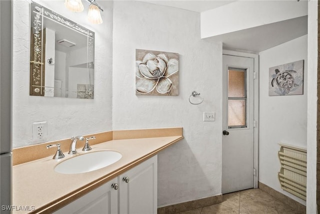 bathroom with tile patterned flooring and vanity