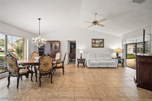 tiled dining space with lofted ceiling, ceiling fan with notable chandelier, and a textured ceiling