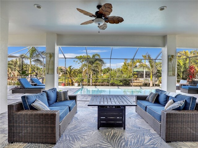 view of patio with ceiling fan, an outdoor living space, and a lanai