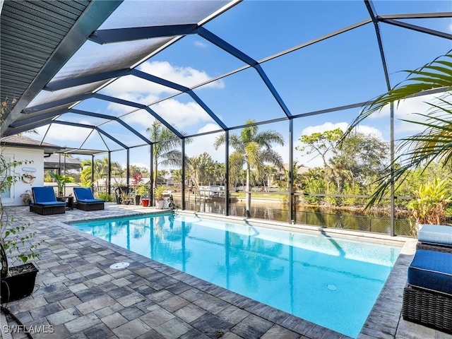 view of swimming pool featuring a water view, a lanai, and a patio area