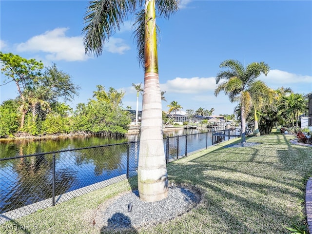 view of dock featuring a yard and a water view