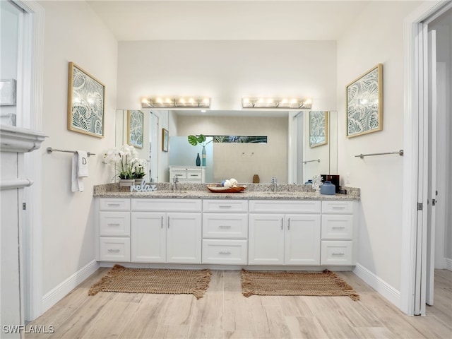 bathroom featuring vanity and hardwood / wood-style floors