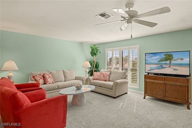 carpeted living room with ceiling fan