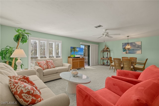 living room with ceiling fan and light colored carpet